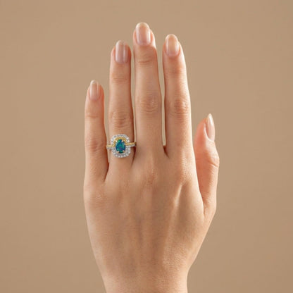 14K yellow gold ring featuring an oval black opal with VS yellow and white diamonds