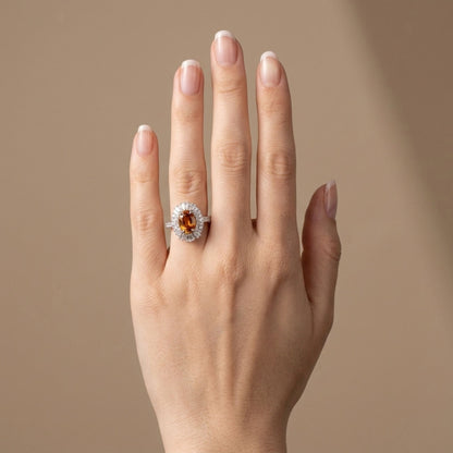 18K gold oval mandarin garnet ring with VS white diamonds