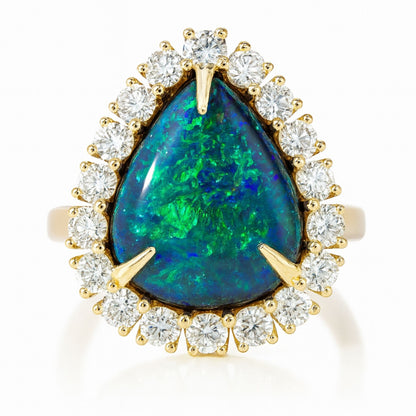 18K yellow gold ring featuring a 3.00ct pear shape black opal surrounded by 1.17cttw VS white diamonds